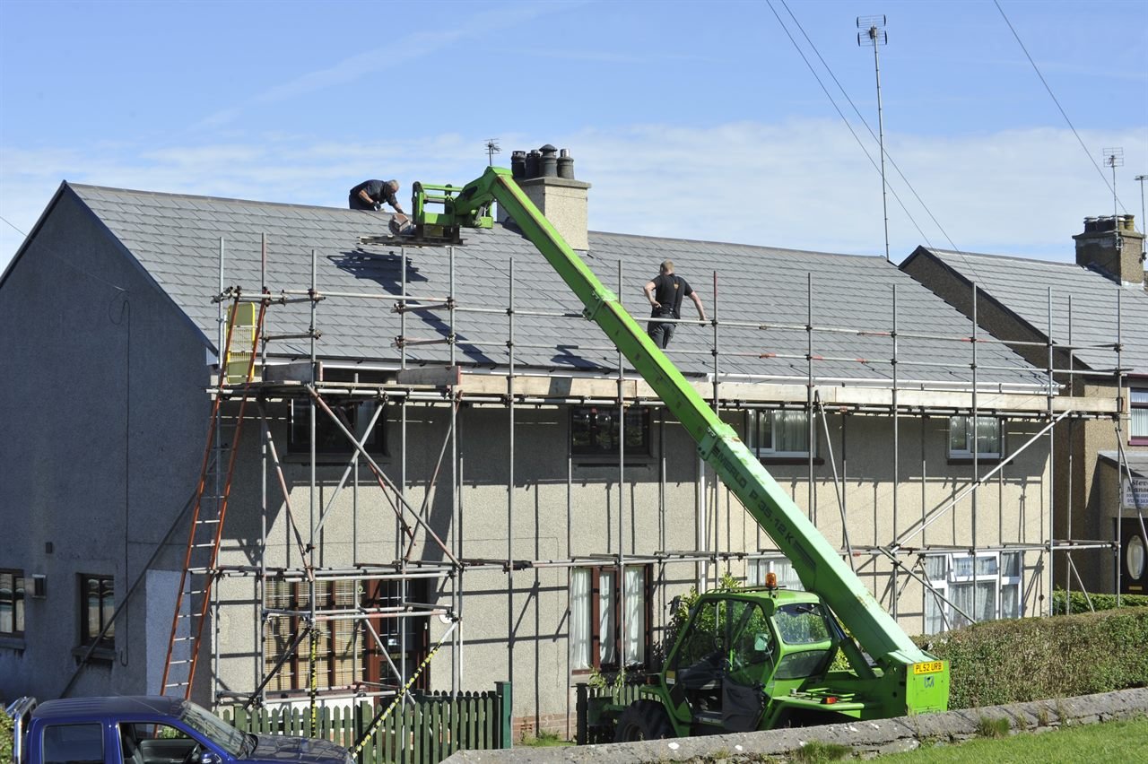 Roofing crew replacing the roof on a residential home in Haverhill, MA