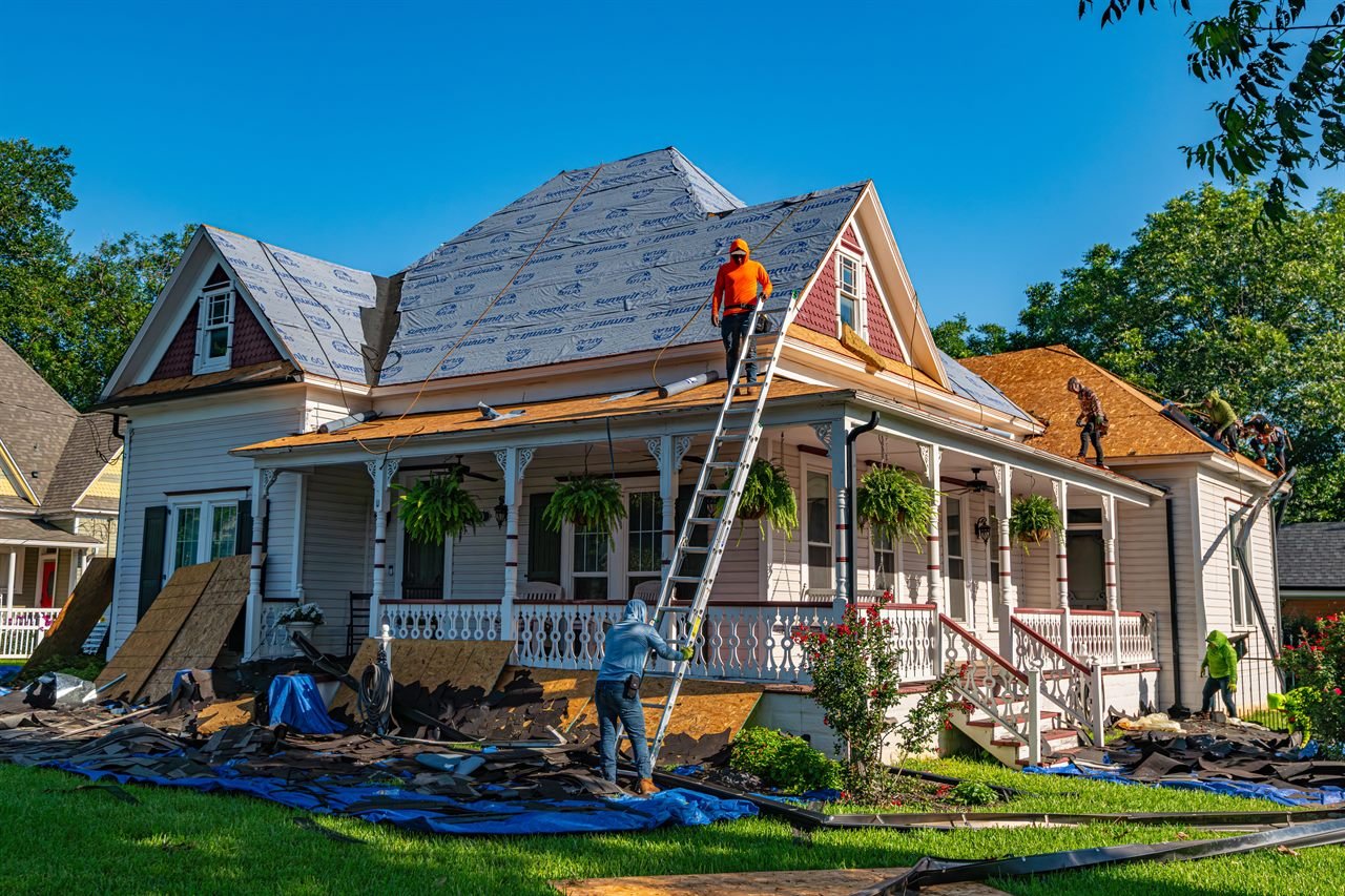 Roofers replacing the roof on a residential home in Haverhill, MA